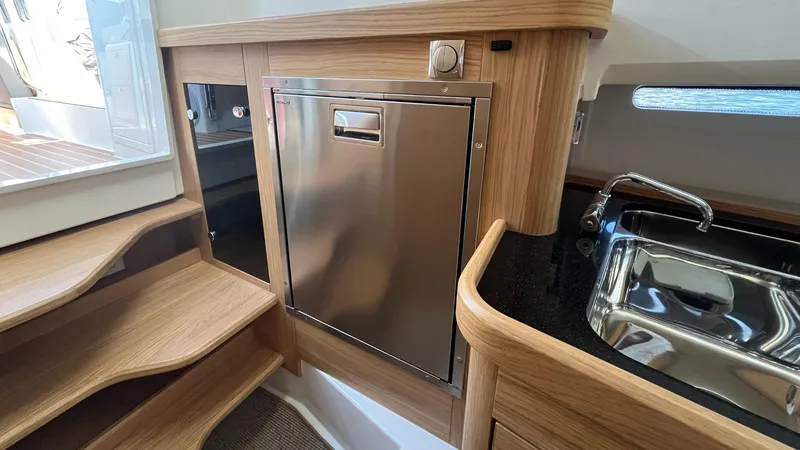 Slide: The Image of Modern kitchen area in 2025 Nimbus Commuter 11 boat with stainless steel appliances. - 32