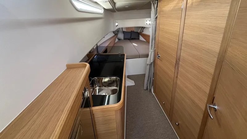 Slide: The Image of Interior of 2025 Nimbus Commuter 11 #086, featuring a compact kitchen and cozy sleeping area. - 33