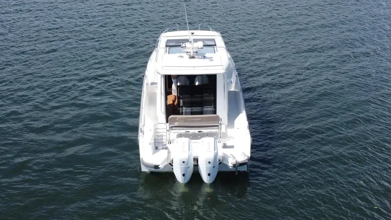 Slide: The Image of Nimbus Commuter 11 #086, 2025 model, white boat on calm water, rear view. - 4