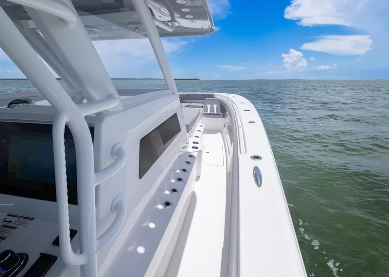 Slide: The Image of 2025 Invincible 43 Open Fisherman boat on calm ocean waters under blue sky. - 11