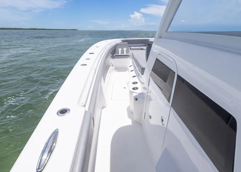 Slide: The Image of 2025 Invincible 43 Open Fisherman boat on open water, showcasing sleek design and spacious deck. - 12