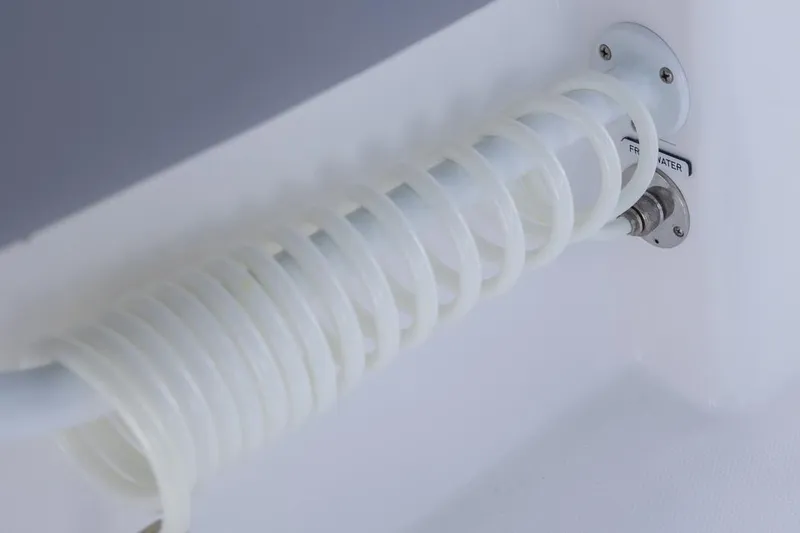 Slide: The Image of Coiled hose on 2025 Invincible 43 Open Fisherman boat, labeled "Fresh Water." - 13