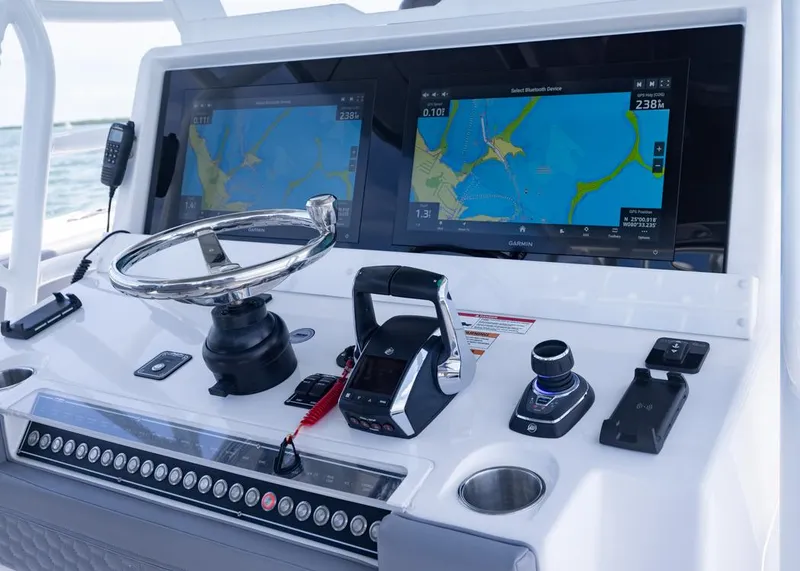 Slide: The Image of 2025 Invincible 43 Open Fisherman dashboard with dual navigation screens and controls. - 17