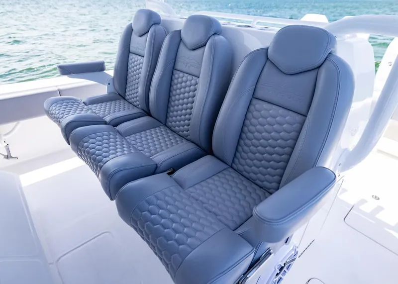 Slide: The Image of Luxurious seating on 2025 Invincible 43 Open Fisherman boat, featuring stylish blue upholstery. - 19