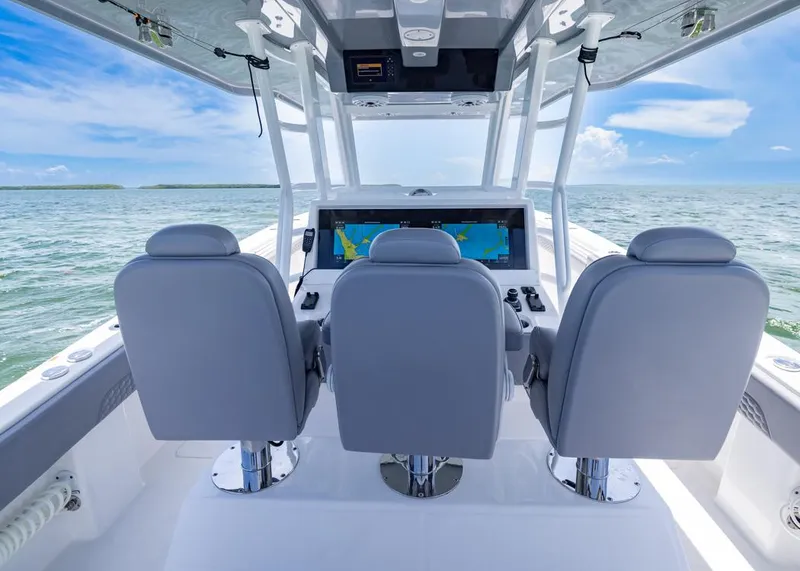 Slide: The Image of 2025 Invincible 43 Open Fisherman boat interior with three helm seats and navigation display. - 22