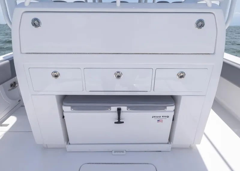 Slide: The Image of 2025 Invincible 43 Open Fisherman boat console with storage drawers and cooler. - 26