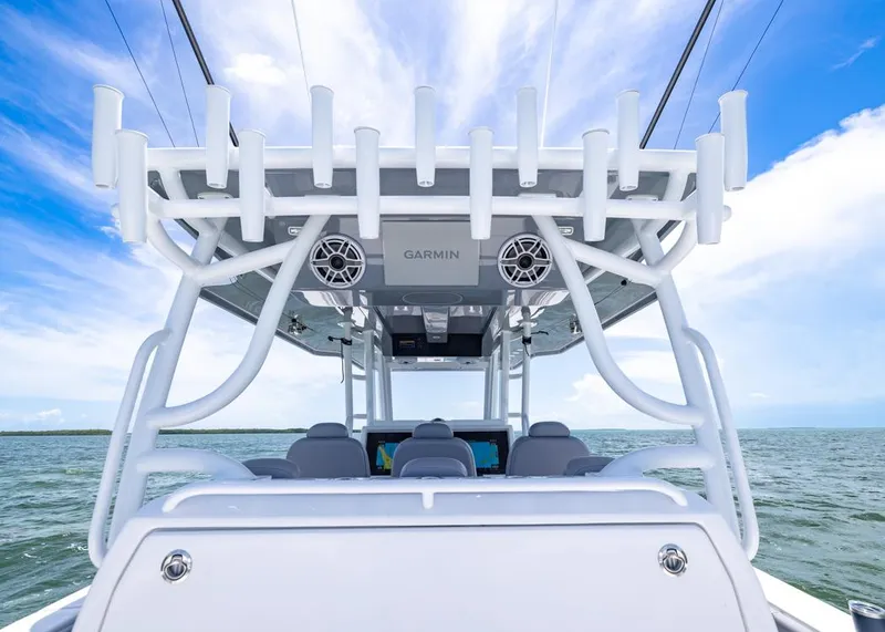 Slide: The Image of 2025 Invincible 43 Open Fisherman boat with rod holders and Garmin electronics on open water. - 28