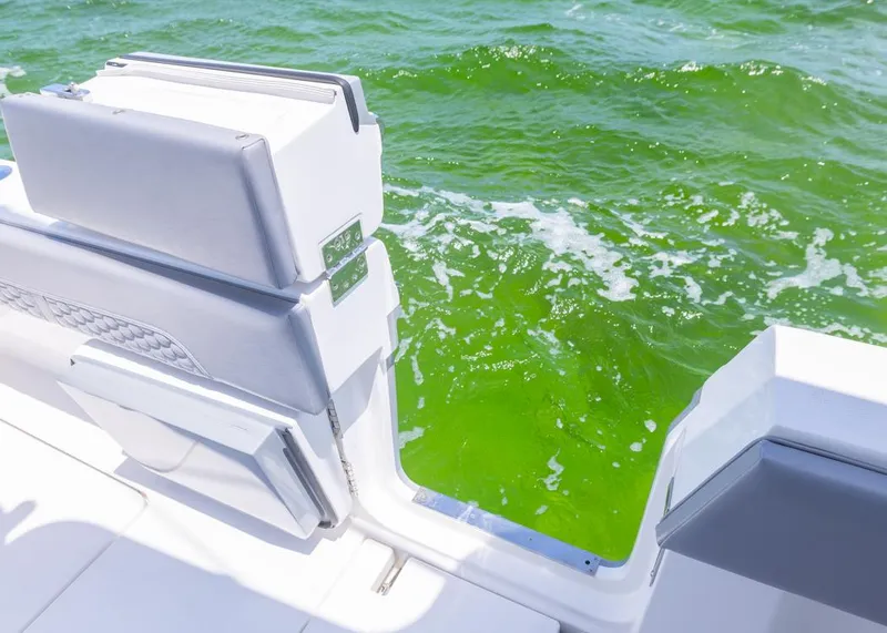 Slide: The Image of 2025 Invincible 43 Open Fisherman boat with open deck, overlooking vibrant green water. - 30