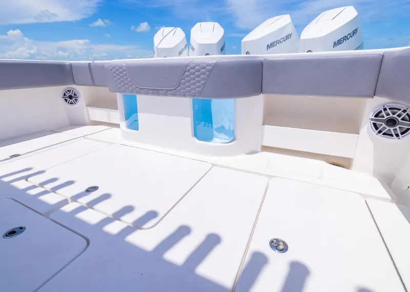 Slide: The Image of 2025 Invincible 43 Open Fisherman boat deck with Mercury engines, featuring sleek design and speakers. - 31