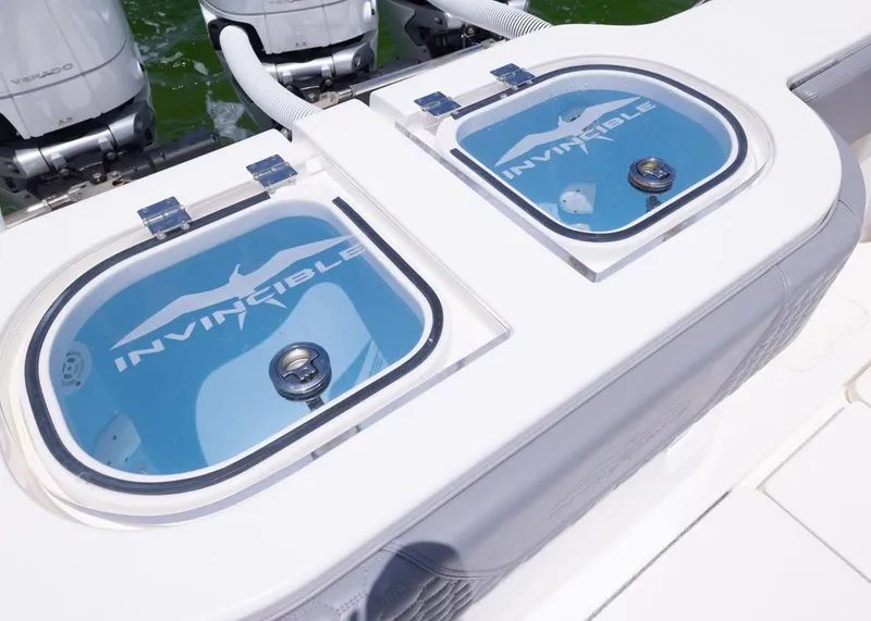 Slide: The Image of 2025 Invincible 43 Open Fisherman livewells with logo, featuring dual outboard engines. - 34