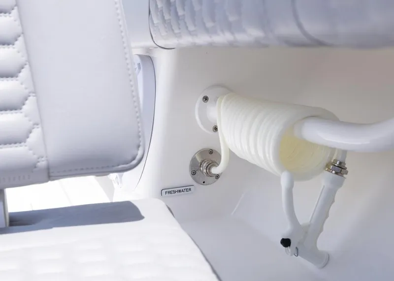 Slide: The Image of 2025 Invincible 43 Open Fisherman freshwater hose detail with white seating. - 36