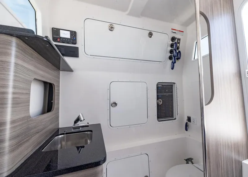 Slide: The Image of Interior of 2025 Invincible 43 Open Fisherman boat, featuring modern cabinetry and control panels. - 40