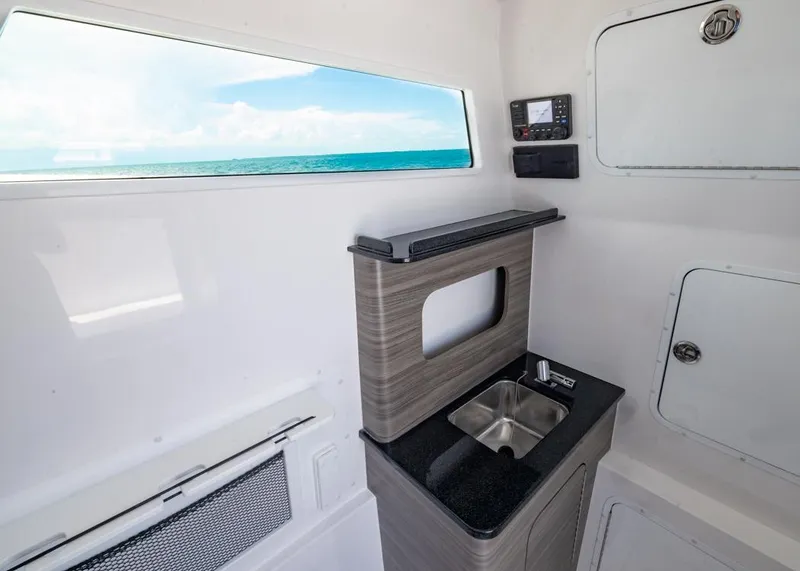 Slide: The Image of Interior of 2025 Invincible 43 Open Fisherman boat with sink and ocean view. - 41