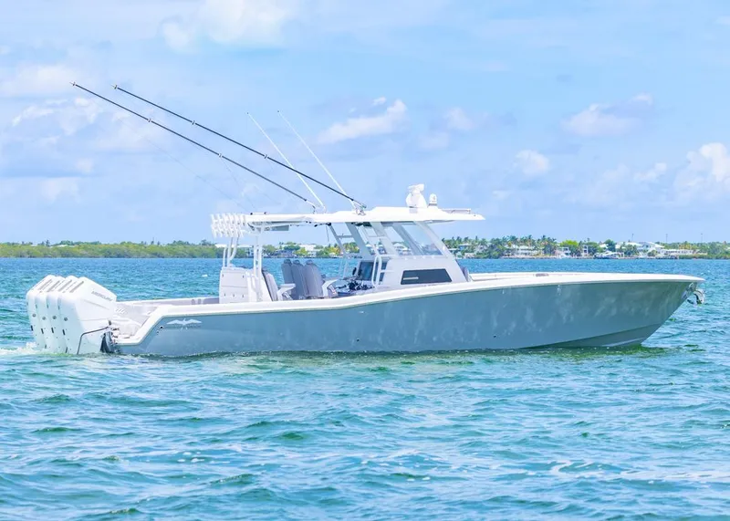 Slide: The Image of 2025 Invincible 43 Open Fisherman boat on calm blue water, clear sky background. - 43