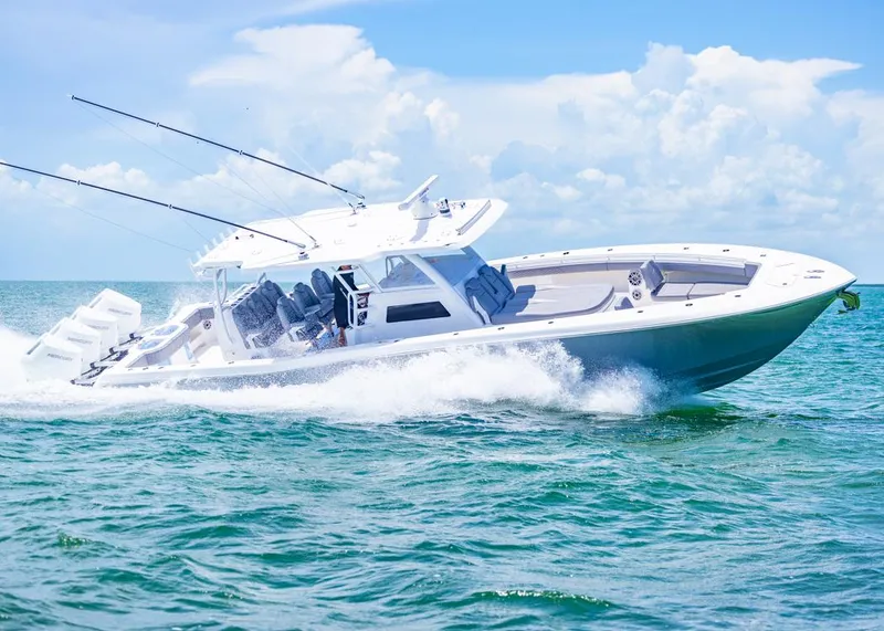 Slide: The Image of 2025 Invincible 43 Open Fisherman boat cruising on clear blue ocean waters. - 49