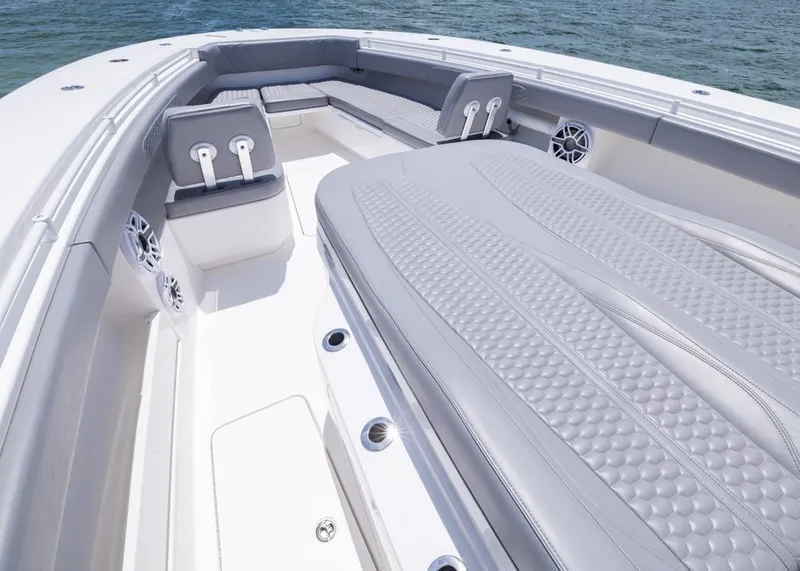 Slide: The Image of 2025 Invincible 43 Open Fisherman boat interior with cushioned seating and ocean view. - 6