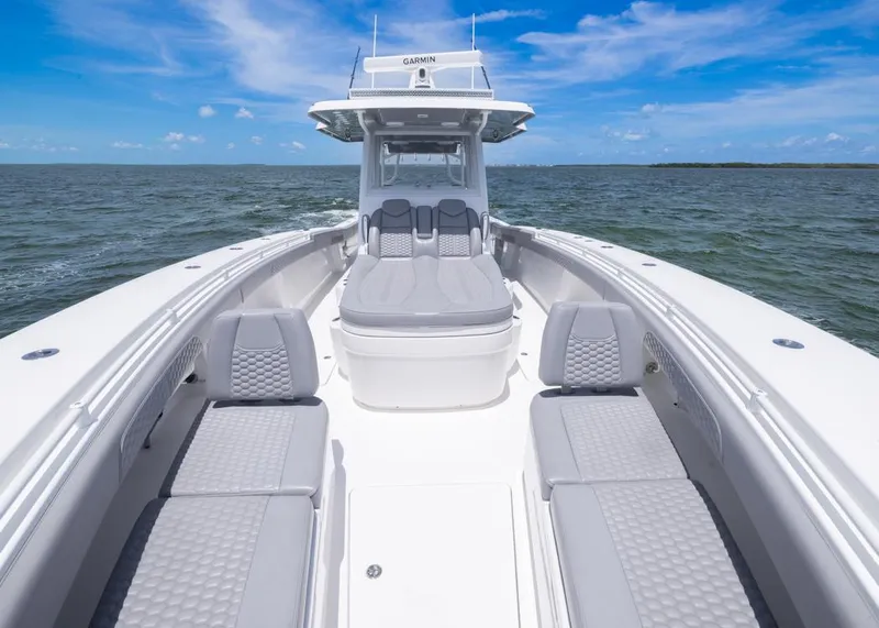 Slide: The Image of 2025 Invincible 43 Open Fisherman boat on open water, featuring sleek seating and modern design. - 9