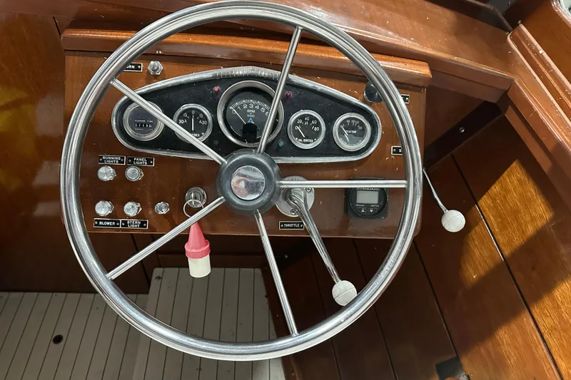 Slide: The Image of 1961 Lyman 21 Runabout dashboard with steering wheel and gauges, showcasing classic wooden design. - 14