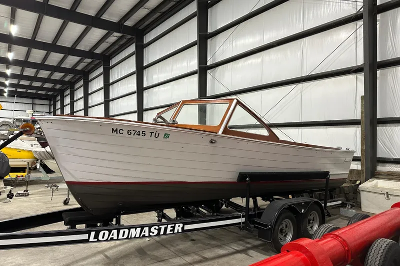 Slide: The Image of 1961 Lyman 21 Runabout boat on Loadmaster trailer in storage facility. - 2