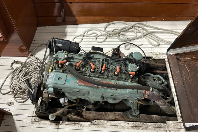 Slide: The Image of 1961 Lyman 21 Runabout engine with ropes on wooden deck. - 20