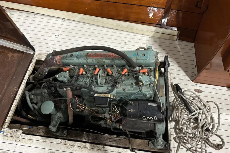 Slide: The Image of 1961 Lyman 21 Runabout engine compartment with visible wiring and ropes. - 21
