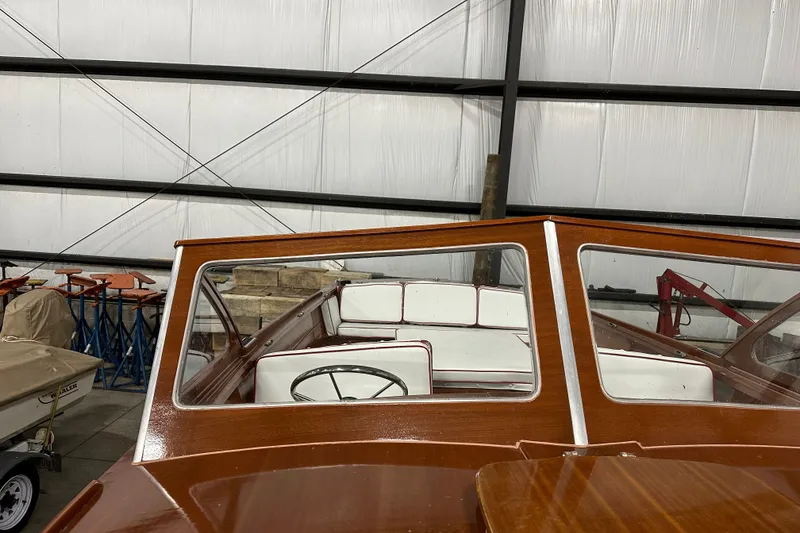 Slide: The Image of 1961 Lyman 21 Runabout boat with wooden interior, stored indoors. - 5