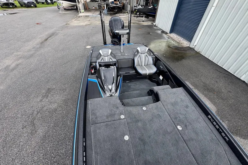 Slide: The Image of 2026 Skeeter ZXE20 boat with sleek design and spacious seating at a marina. - 12