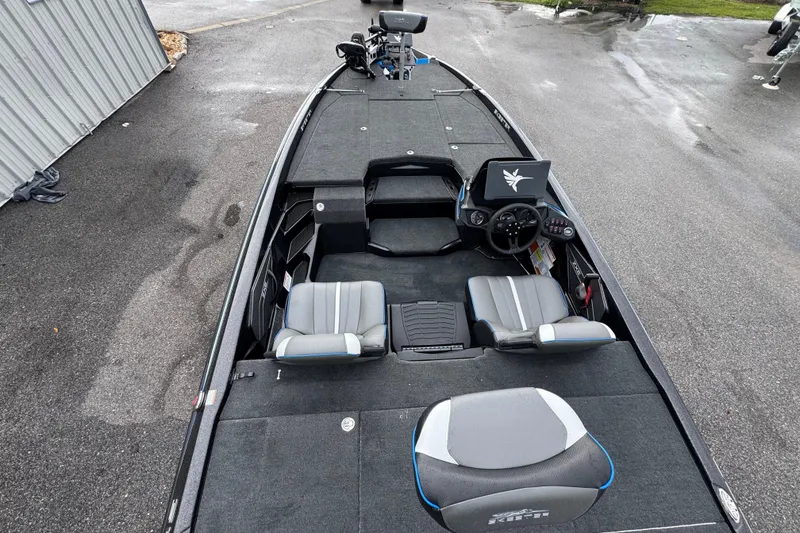 Slide: The Image of 2026 Skeeter ZXE20 boat interior with modern dashboard and seating on wet pavement. - 14