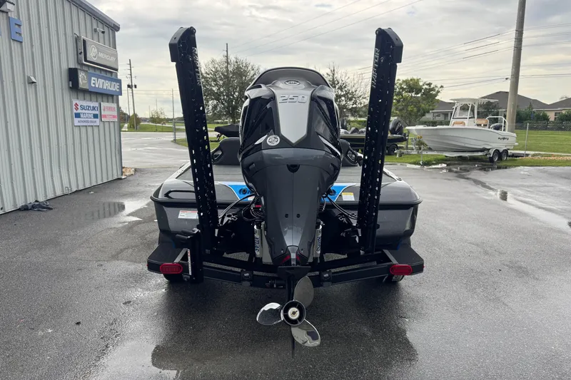 Slide: The Image of 2026 Skeeter ZXE20 boat with powerful outboard motor, parked near marine dealership. - 21