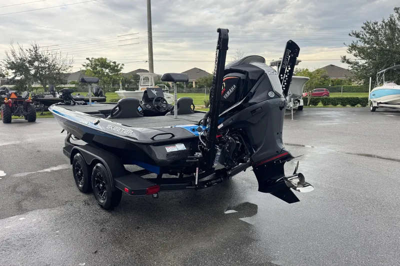 Slide: The Image of 2026 Skeeter ZXE20 boat with Yamaha engine on a trailer in a parking lot. - 23