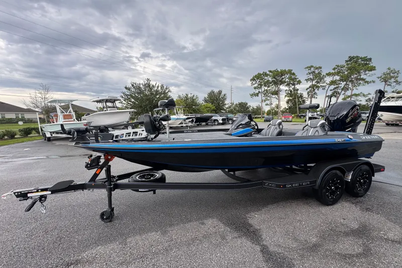 Slide: The Image of 2026 Skeeter ZXE20 boat on trailer, parked outdoors under cloudy sky. - 5