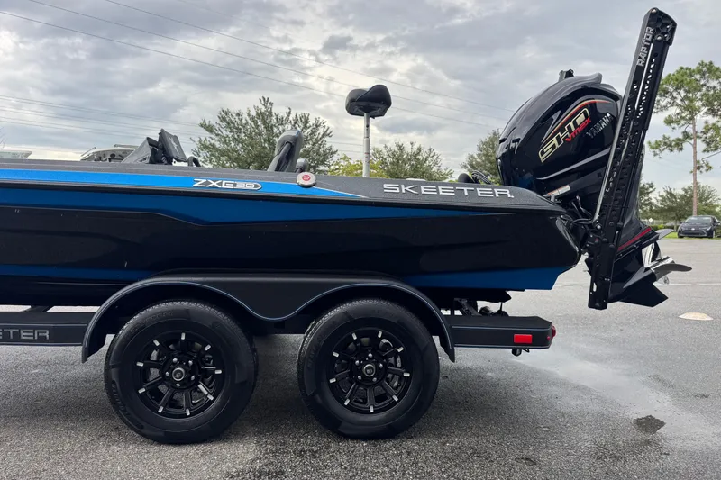 Slide: The Image of 2026 Skeeter ZXE20 boat on trailer with Yamaha motor, parked outdoors. - 7