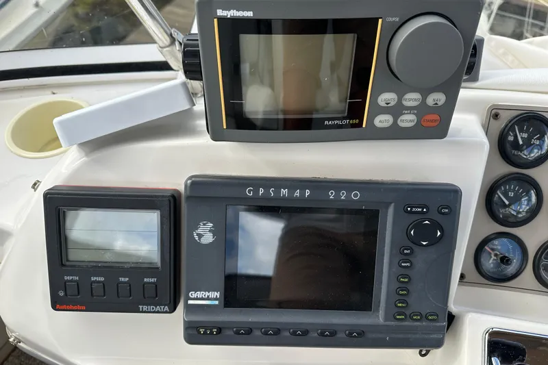 Slide: The Image of Control panel of a 1997 Carver 325 Motor Yacht with navigation instruments. - 14