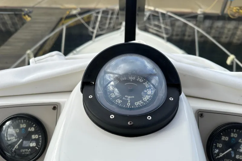Slide: The Image of Compass and gauges on 1997 Carver 325 Motor Yacht dashboard at dock. - 17