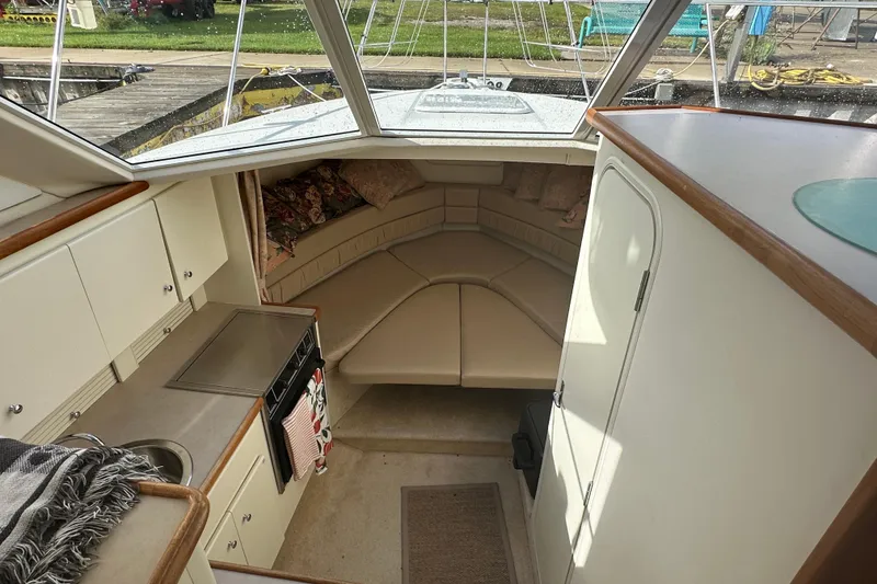 Slide: The Image of Interior of 1997 Carver 325 Motor Yacht with cozy seating and kitchenette. - 22