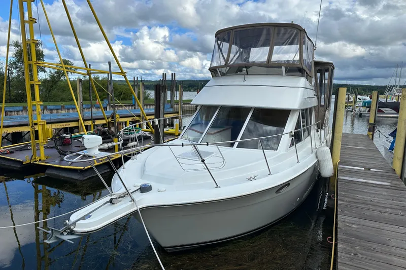 Slide: The Image of 1997 Carver 325 Motor Yacht docked at marina under cloudy sky. - 3