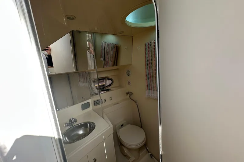 Slide: The Image of Bathroom interior of 1997 Carver 325 Motor Yacht with sink, toilet, and mirror. - 31