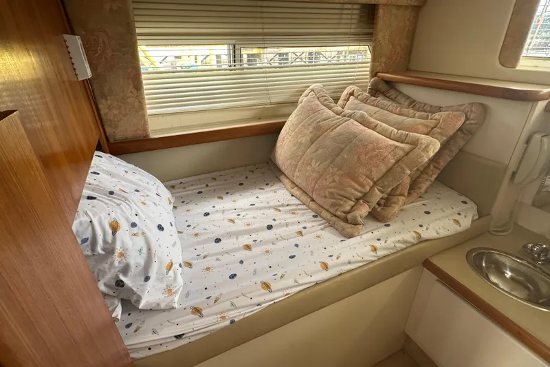Slide: The Image of Cozy cabin bed in 1997 Carver 325 Motor Yacht with pillows and patterned sheets. - 34