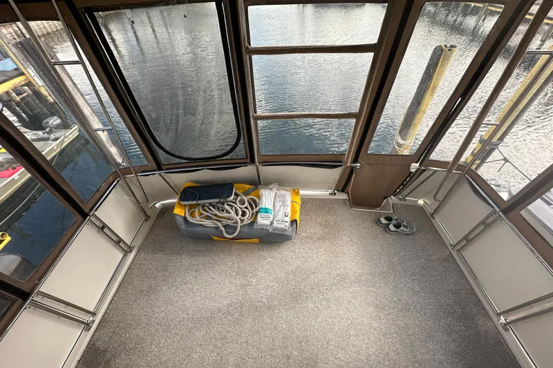 Slide: The Image of 1997 Carver 325 Motor Yacht interior with ropes and gear, docked by the water. - 36