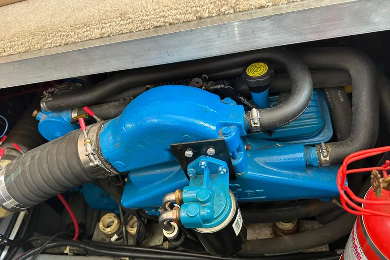 Slide: The Image of Engine compartment of a 1997 Carver 325 Motor Yacht with blue components and hoses. - 39