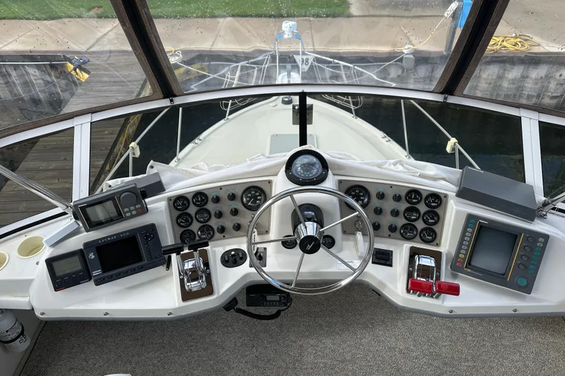 Slide: The Image of Cockpit view of a 1997 Carver 325 Motor Yacht with navigation instruments and steering wheel. - 13