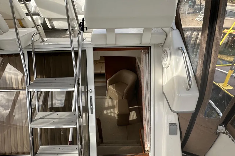 Slide: The Image of Interior view of 1997 Carver 325 Motor Yacht with stairs and seating area. - 21