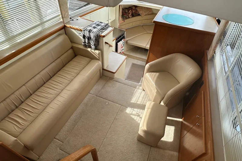 Slide: The Image of Interior of 1997 Carver 325 Motor Yacht with beige seating and wood accents. - 23
