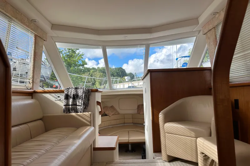 Slide: The Image of Interior of 1997 Carver 325 Motor Yacht with plush seating and large windows. - 27