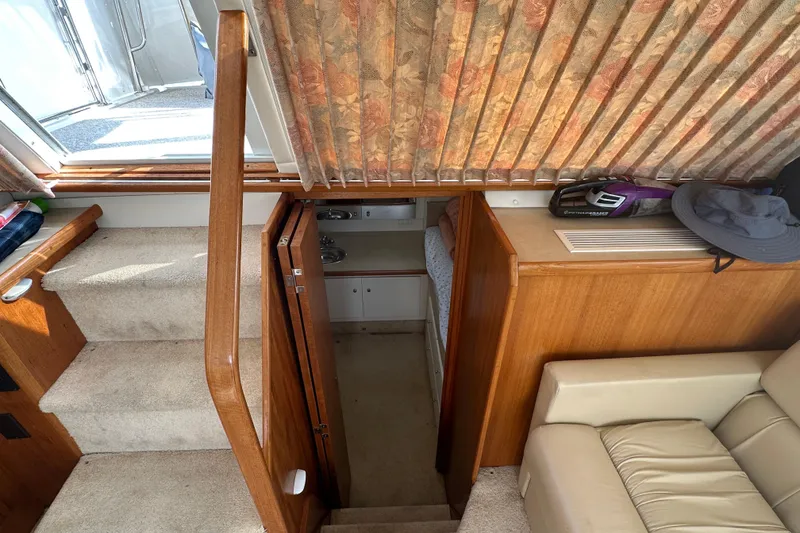 Slide: The Image of Interior of 1997 Carver 325 Motor Yacht with stairs, seating, and cabin entrance. - 33