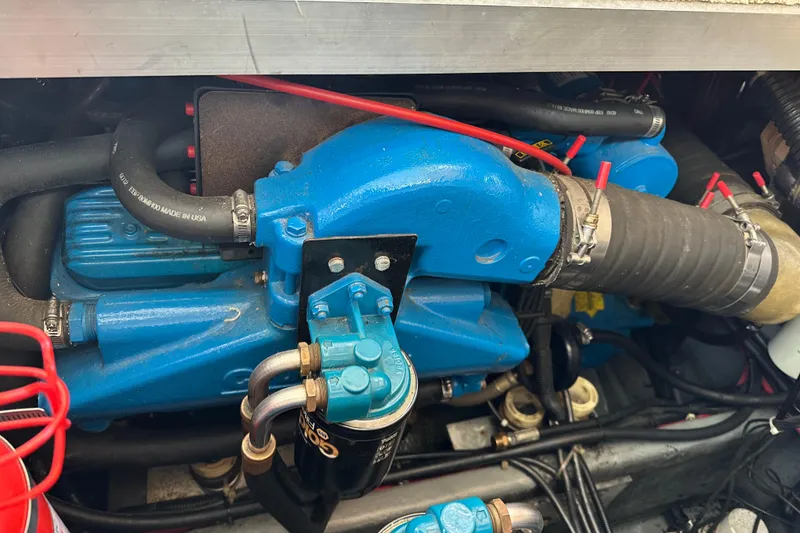 Slide: The Image of Engine compartment of a 1997 Carver 325 Motor Yacht, featuring blue components and hoses. - 37