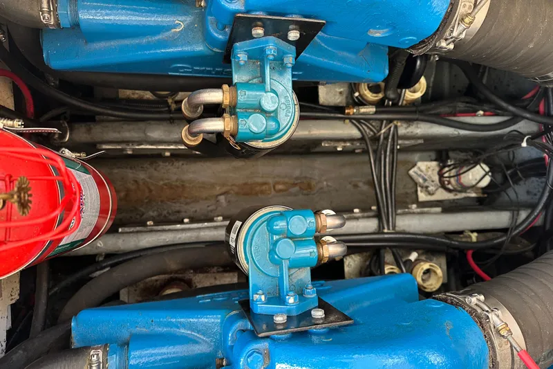 Slide: The Image of Engine room of 1997 Carver 325 Motor Yacht with blue components and fire extinguisher. - 38