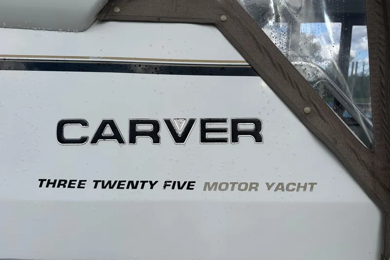 Slide: The Image of 1997 Carver 325 Motor Yacht logo on white surface with raindrops. - 40