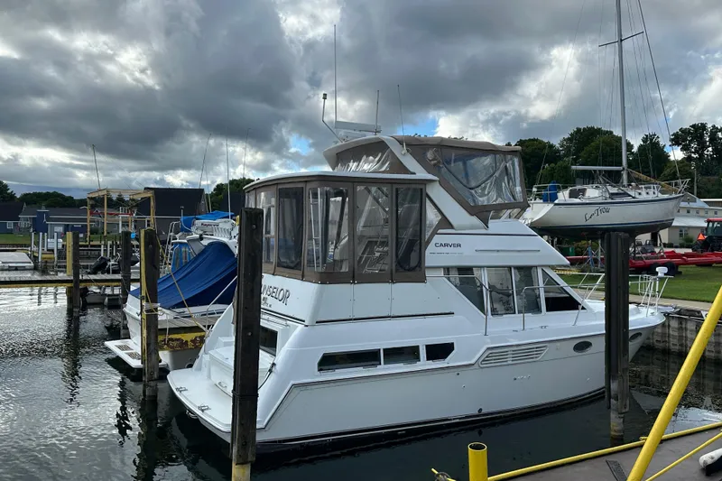 Slide: The Image of 1997 Carver 325 Motor Yacht docked at a marina under cloudy skies. - 6