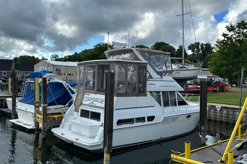Slide: The Image of 1997 Carver 325 Motor Yacht docked at a marina under cloudy skies. - 7